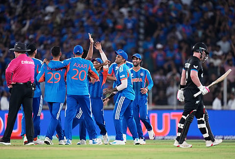 India's players celebrate the wicket of New Zealand's Tim Seifert, right, during the T20 World Cup cricket final match between India and New Zealand in Ahmedabad.