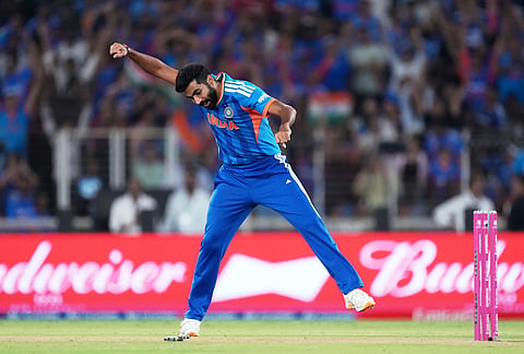 India's Jasprit Bumrah celebrates the wicket of New Zealand's James Neesham during the T20 World Cup cricket final match between India and New Zealand in Ahmedabad.