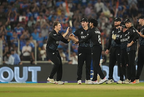 New Zealand players celebrate the wicket of India's Abhishek Sharma during the T20 World Cup cricket final match between India and New Zealand in Ahmedabad.
