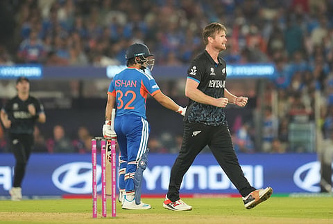 New Zealand's James Neesham celebrates the wicket of India's Ishan Kishan during the T20 World Cup cricket final match between India and New Zealand in Ahmedabad.