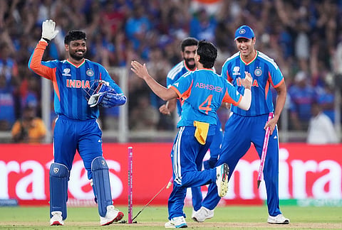 India's players celebrate after winning the T20 World Cup cricket final match against New Zealand in Ahmedabad.