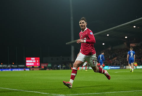 Wrexham's Callum Doyle celebrates after scoring during the fifth round FA Cup soccer match between Wrexham and Chelsea in Wrexham, Wales