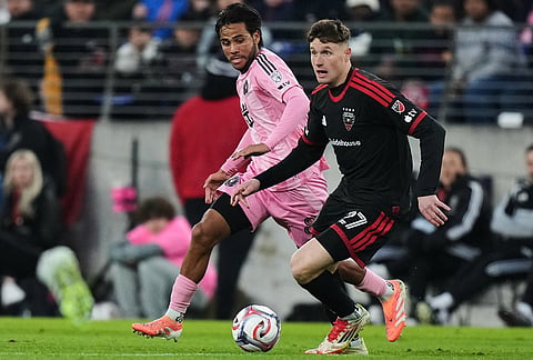 D.C. United defender Nikola Marković (27) advances past Inter Miami midfielder Telasco Segovia (8) during the second half of an MLS soccer match, in Baltimore.