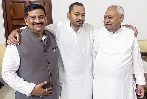Bihar Chief Minister Nitish Kumar, right, with JD(U) National Working President Sanjay Jha, left, and Nitish Kumar's son Nishant Kumar after he joins the Janata Dal (United) JD(U), in Patna, Bihar.
