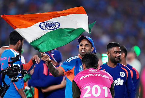 India's captain Suryakumar Yadav carries the Indian national flag after winning the T20 World Cup cricket final match against New Zealand in Ahmedabad.