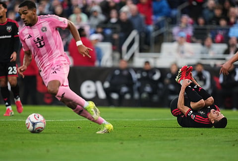 D.C. United midfielder Gabriel Pirani, right, reacts after an injury as Inter Miami midfielder Yannick Bright, front left, advances with the ball during the first half of an MLS soccer match, in Baltimore.