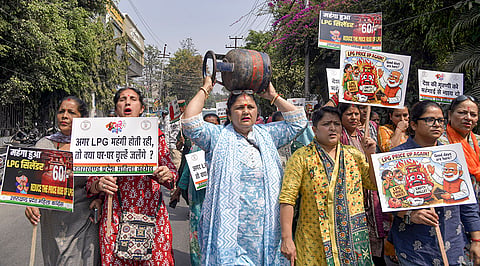 Uttarakhand Pradesh Mahila Congress President Jyoti Rautela, yellow, with party workers stages a protest against the LPG price hike, in Dehradun.