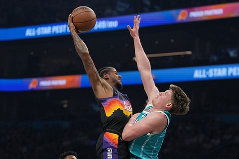 Phoenix Suns guard Jalen Green (4) shoots over Charlotte Hornets guard Kon Knueppel during the first half of an NBA basketball game in Phoenix.