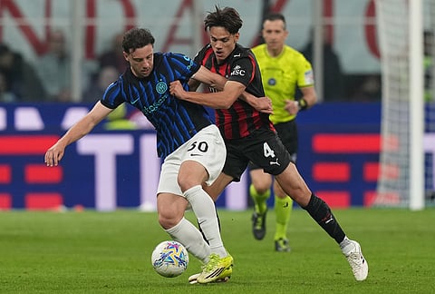 Inter Milan's Carlos Augusto, left, and AC Milan's Samuele Ricci fight for the ball during the Serie A soccer match between AC Milan and Inter Milan, in Milan, Italy.