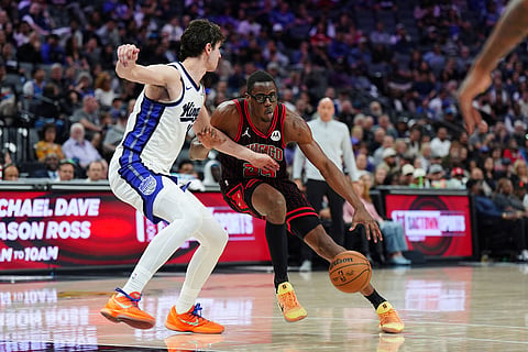 Chicago Bulls forward Jalen Smith (25) handles the ball against Sacramento Kings center Maxime Raynaud (42) during the second half of an NBA basketball game in Sacramento, Calif.