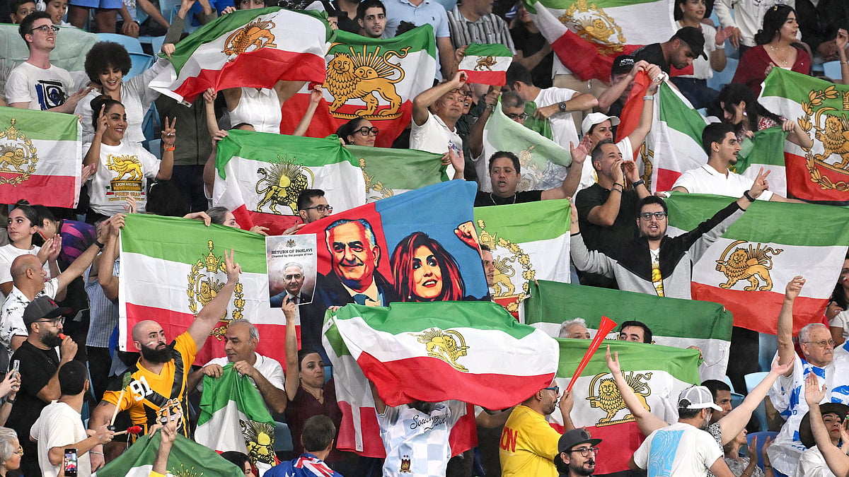 Iran supporters wave flags during the Women's Asian Cup soccer match between Iran and the Philippines in Robina, Australia, Sunday, March 8, 2026. - | Photo: AP/DAVE HUNT
