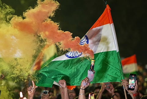 Cricket fans waving the country's national flag celebrate after India defeated New Zealand final match of T20 World Cup in Lucknow Uttar Pradesh.