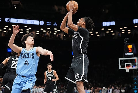 Brooklyn Nets' Ziaire Williams (1) shoots over Memphis Grizzlies' Walter Clayton Jr. (4) during the first half of an NBA basketball game in New York.