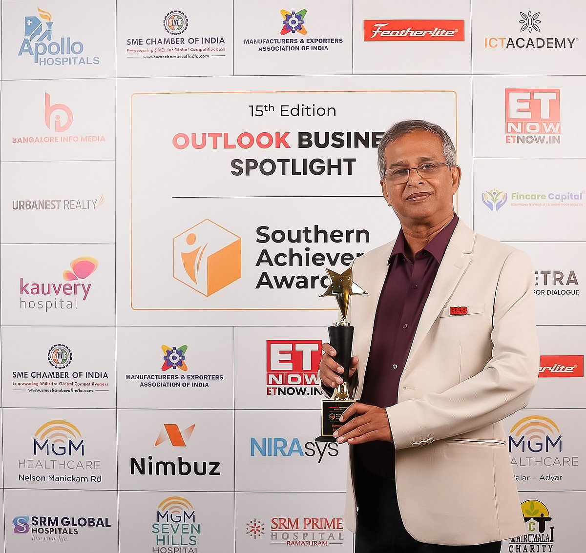 Bobby Benedict holding southern achivers awards