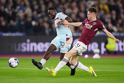 Brentford's Michael Kayode, left, and West Ham United's Oliver Scarles in action during the English FA Cup fifth round soccer match between West Ham United and Brentford in London.