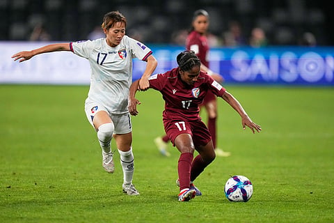 Taiwan's Chen Jin-wen, left, and India's Rimpa Haldar vie for the ball during the Women's Asian Cup soccer match between India and Taiwan in Sydney.