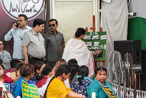 West Bengal Chief Minister Mamata Banerjee paints on a canvas, during a five-day sit-in dharna against alleged arbitrary deletions from the post-SIR electoral rolls, in Kolkata.