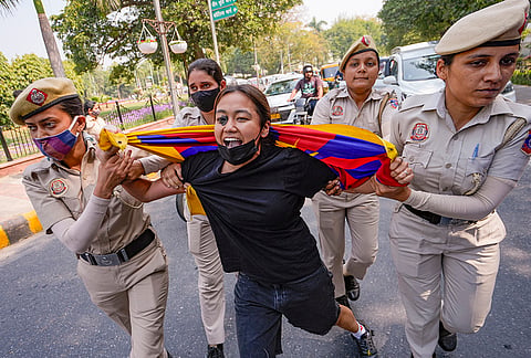 Police personnel detain a Tibetan Youth Congress member during a demonstration marking the '67th National Uprising Day', near Chinese Embassy, in New Delhi.