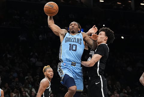 Memphis Grizzlies' Javon Small, center, shoots over Brooklyn Nets' Nolan Traore, right, and Noah Clowney during the second half of an NBA basketball game in New York.