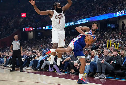 Philadelphia 76ers guard Quentin Grimes, right, is defended by Cleveland Cavaliers guard James Harden (1) in the second half of an NBA basketball game in Cleveland.