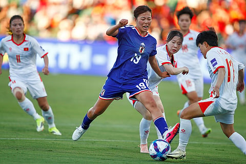 Japan's Momoko Tanikawa and Vietnam's Trần Thị Thu Thảo, right, compete for the ball during the Women's Asian Cup soccer match between Japan and Vietnam in Perth, Australia.