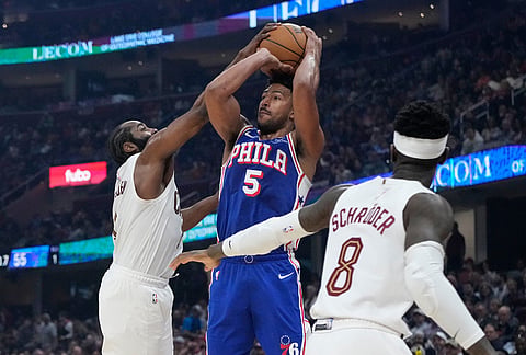 Philadelphia 76ers guard Quentin Grimes (5) is defended by Cleveland Cavaliers guard James Harden, left, in the second half of an NBA basketball game in Cleveland.