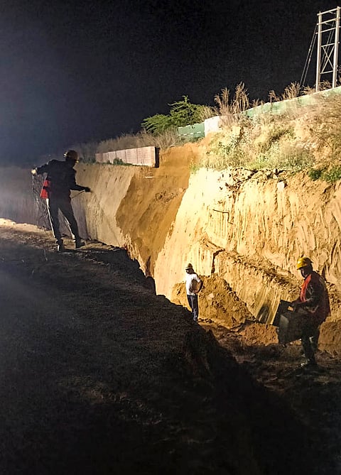 Rescue personnel carry out an operation after an under-construction wall collapsed on Monday, in Gurugram. Around 12-15 workers were trapped and seven were killed in the incident. 