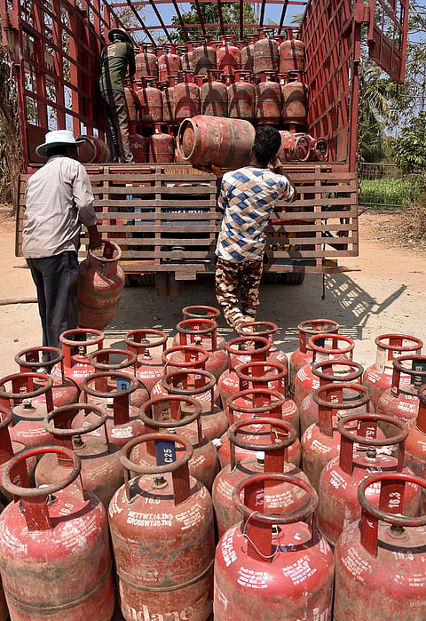 Workers load LPG cylinders in a truck, in Chikkamagaluru, Karnataka. The prices of domestic LPG and commercial cylinders were hiked by a steep Rs 60 and Rs 114.5, respectively, amid rising energy costs linked to the West Asia conflict. 
