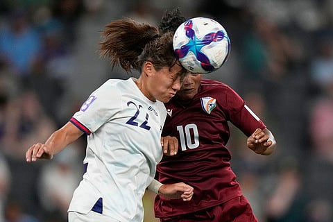 Taiwan's Huang Ke-sin, left, and India's Pyari Xaxa vie for the ball during the Women's Asian Cup soccer match between India and Taiwan in Sydney.