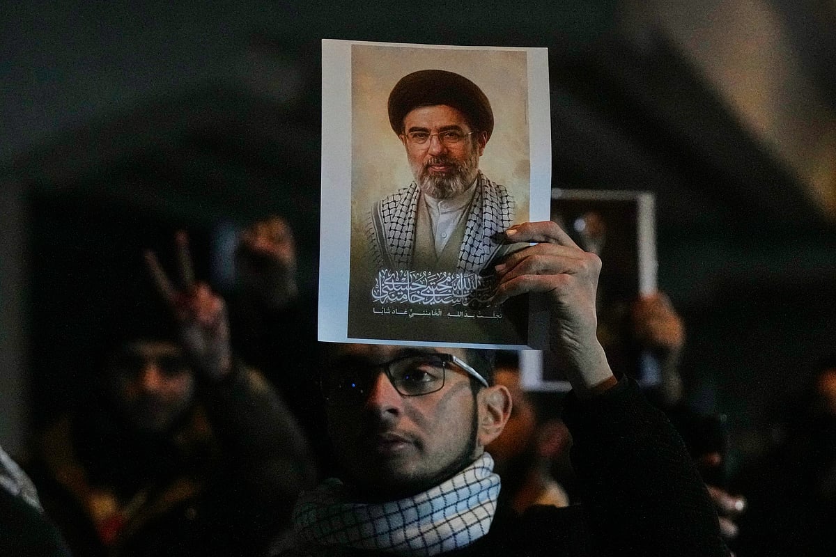 
Iraqis hold a portrait of the new successor to Supreme Leader, Ayatollah Mojtaba Khamenei at a bridge leading to the fortified Green Zone where the U.S. embassy is located in Baghdad, Iraq, Monday, March 9, 2026. 