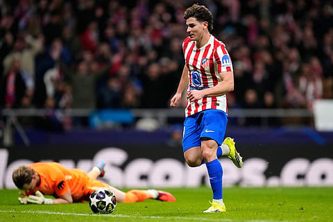 Atletico Madrid's Julian Alvarez goes round Tottenham's goalkeeper Antonin Kinsky to score his side's third goal during the first leg of the Champions League round of 16 soccer match between Atletico Madrid and Tottenham in Madrid, Spain.