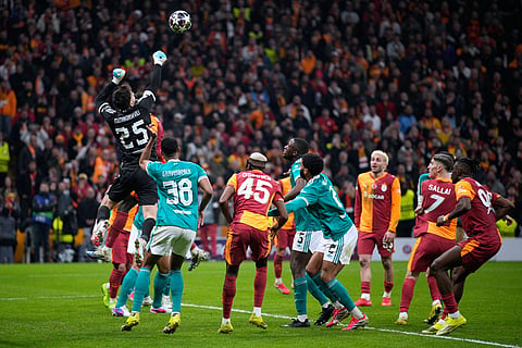 Liverpool's goalkeeper Giorgi Mamardashvili, top left, defends a high ball during a Champions League round of 16 first leg soccer match between Galatasaray and Liverpool, in Istanbul, Turkey.