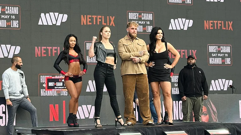 Ronda Rousey, center left, and Gina Carano, right, pose with promoter Jake Paul, center right, during a news conference in Inglewood, Calif., Tuesday, March 10, 2026. - AP