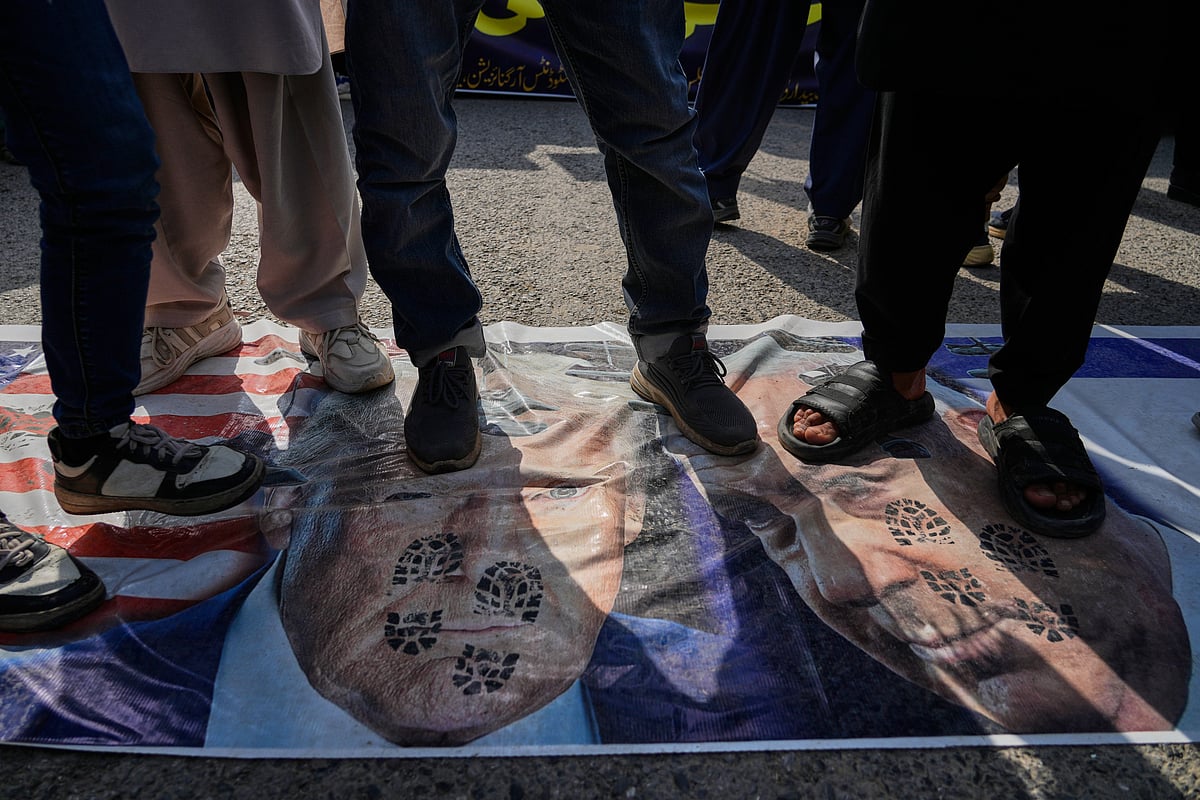 AP
 : 
Shiite Muslims stands over the representation of U.S. and Israeli flags with pictures of President Donald Trump and Prime Minister Benjamin Netanyahu during a rally to condemn the killing of Iranian Supreme Leader Ayatollah Ali Khamenei and against the Israeli strikes on Iran