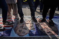The Paradox Of Intervention: War And Politics In Iran AP
:
Shiite Muslims stands over the representation of U.S. and Israeli flags with pictures of President Donald Trump and Prime Minister Benjamin Netanyahu during a rally to condemn the killing of Iranian Supreme Leader Ayatollah Ali Khamenei and against the Israeli strikes on Iran