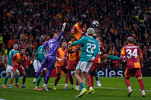 Galatasaray's Wilfried Singo, top, heads the ball during a Champions League round of 16 first leg soccer match between Galatasaray and Liverpool, in Istanbul, Turkey.