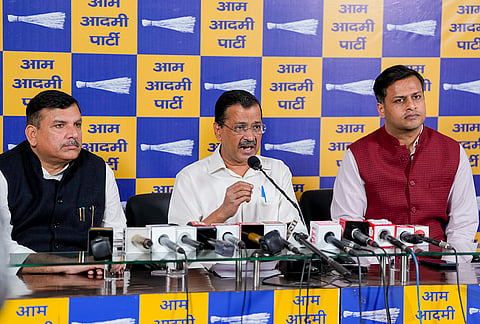 AAP national convener Arvind Kejriwal, centre, party MP Sanjay Singh, left, and party leader Jasmine Shah, during a press conference over "heavy" LPG shortage across the country, at party office in New Delhi.