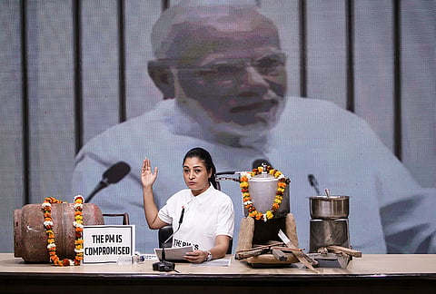 All India Mahila Congress president Alka Lamba addresses a press conference with an LPG cylinder and 'chulha', traditional Indian stoves and cooking utensils placed on the table as props, at the AICC headquarters, in New Delhi.