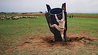 Photo: AP : Unexploded Ordnance: A boy tries to climb an Iranian projectile in Syria on March 4, 2026