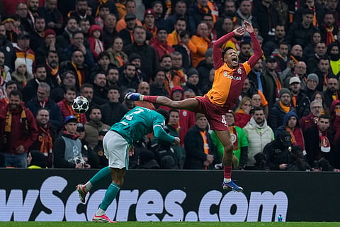 Galatasaray's Ismail Jakobs, right, and Liverpool's Joe Gomez fight for a high ball during a Champions League round of 16 first leg soccer match between Galatasaray and Liverpool, in Istanbul, Turkey.