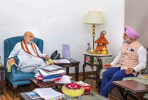 Union Home Minister Amit Shah meets Delhi Lt Governor-designate Taranjit Singh Sandhu before his swearing-in, in New Delhi. 