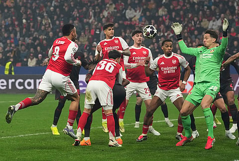 Arsenal's Gabriel Jesus, left, heads the ball as Leverkusen's goalkeeper Janis Blaswich, right, makes a save during the Champions League round of 16 first leg soccer match between Bayer Leverkusen and Arsenal FC in Leverkusen, Germany.
