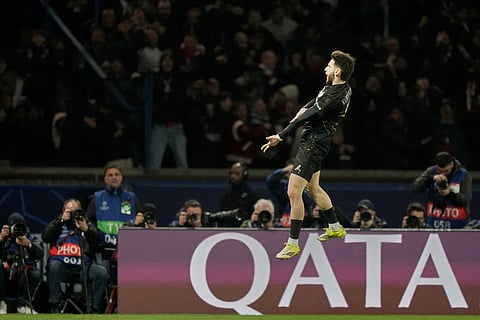 PSG's Khvicha Kvaratskhelia celebrates after scoring his side's fourth goal during the first leg of the Champions League round of 16 soccer match between Paris Saint-Germain and Chelsea, in Paris.
