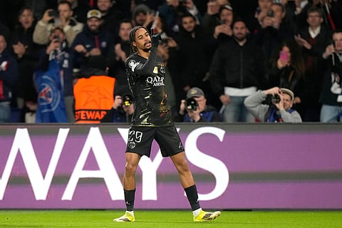 PSG's Bradley Barcola celebrates after scoring the opening goal during the first leg of the Champions League round of 16 soccer match between Paris Saint-Germain and Chelsea, in Paris.