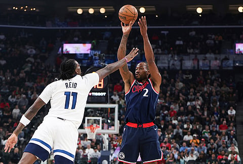 Los Angeles Clippers forward Kawhi Leonard (2) shoots against Minnesota Timberwolves center Naz Reid (11) during the first half of an NBA basketball game, in Inglewood, California.