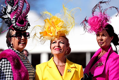 Racegoers attend Ladies Day of the 2026 Cheltenham Festival at Cheltenham Racecourse, England.