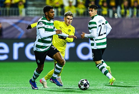 Bodo/Glimt's Fredrik Sjovold, centre, and Sporting's Luis Guilherme, left, fight for the ball during the Champions League soccer match between Bodo/Glimt and Sporting Lisbon, in Bodo, Norway.