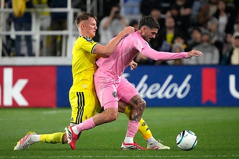 Nashville SC forward Sam Surridge, left, tries to stop Inter Miami midfielder Rodrigo de Paul in the second half of a CONCACAF Champions Cup Round of 16 soccer match in Nashville, Tenn.
