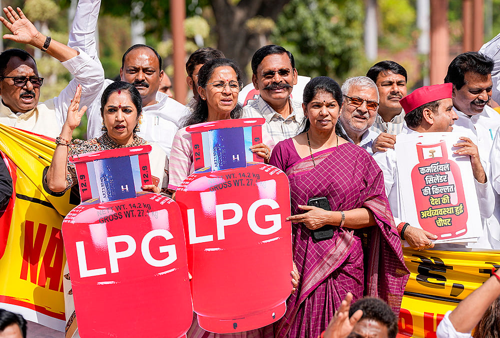| Photo: PTI/Ravi Choudhary : NCP (SP) MP Supriya Sule, DMK MP Kanimozhi Karunanidhi, Samajwadi Party MP Dharmendra Yadav, and others, stage a protest in Parliament premises over 'LPG shortage' during the second part of Budget session, in New Delhi.