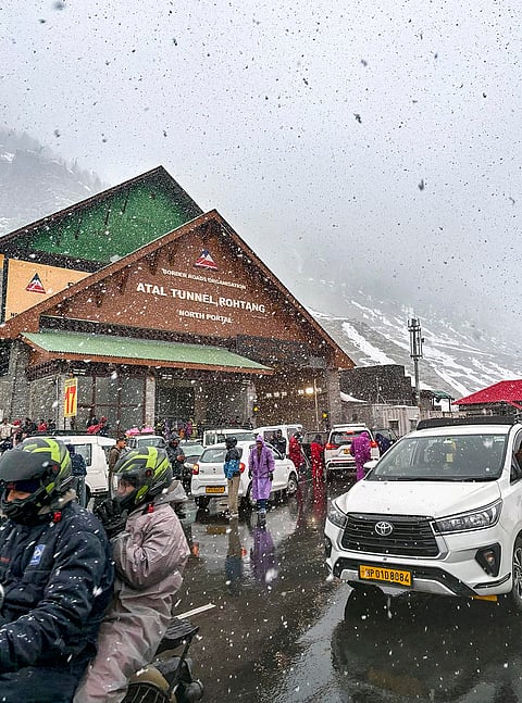 Tourists arrive at the North Portal of the Atal Tunnel amid snowfall, in Lahaul and Spiti district of Himachal Pradesh.